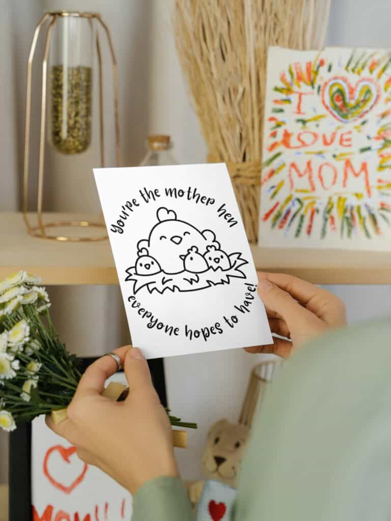 "Mother hen" mother's day coloring card held in a woman's hand.